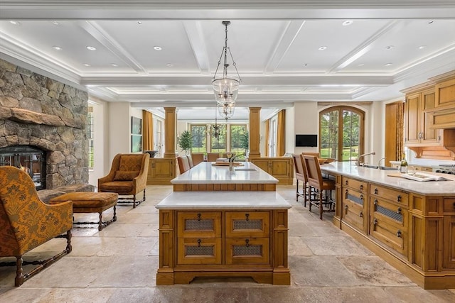 180 Ash St, Weston, MA 02493 - dining space with decorative columns, stone tile floors, coffered ceiling, a fireplace, and beam ceiling