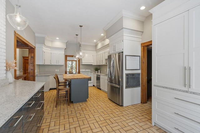 kitchen with brick floor, recessed lighting, stainless steel appliances, butcher block countertops, and a kitchen breakfast bar