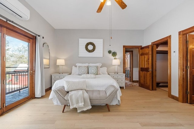 bedroom with access to exterior, light wood-type flooring, an AC wall unit, and baseboards