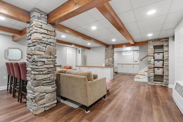 living area with a paneled ceiling, recessed lighting, wood finished floors, stairway, and beam ceiling