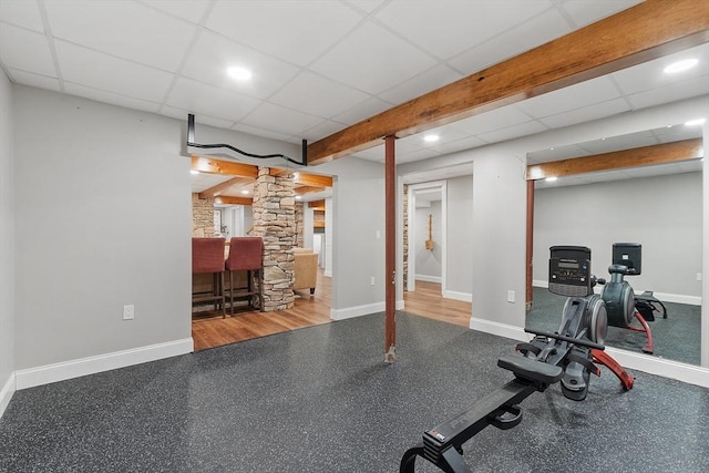 workout room with recessed lighting, a drop ceiling, decorative columns, and baseboards