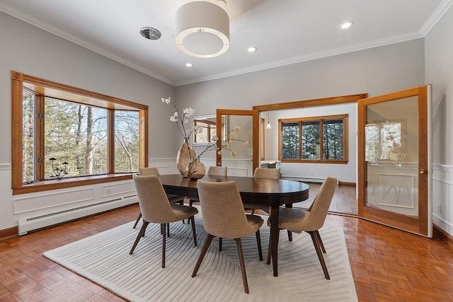 dining area with a baseboard heating unit, recessed lighting, wainscoting, and crown molding