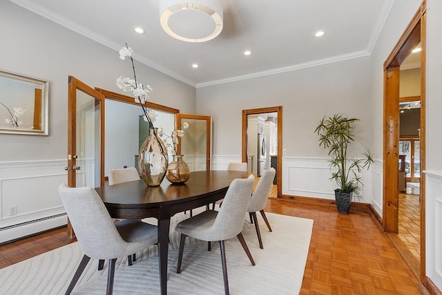 dining room with wainscoting, ornamental molding, a decorative wall, a notable chandelier, and recessed lighting