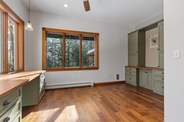 interior space with recessed lighting, dark wood-type flooring, visible vents, baseboards, and baseboard heating