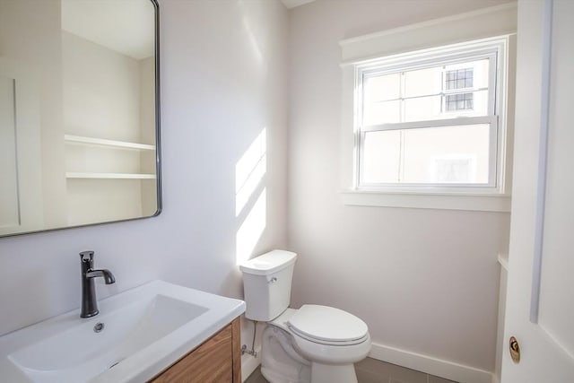 bathroom featuring tile patterned floors, vanity, and toilet