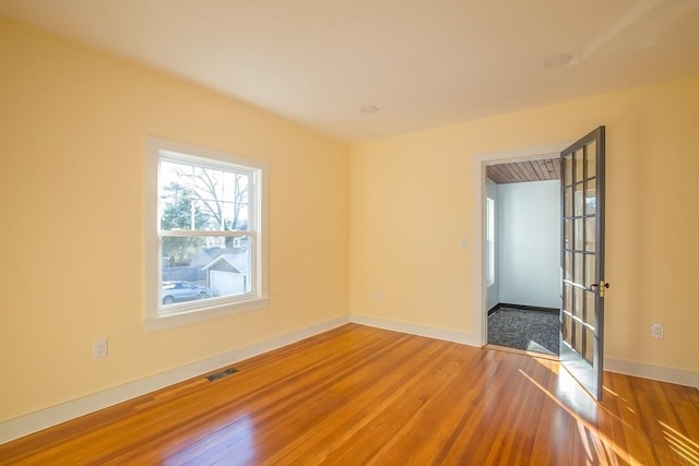 unfurnished room featuring hardwood / wood-style floors