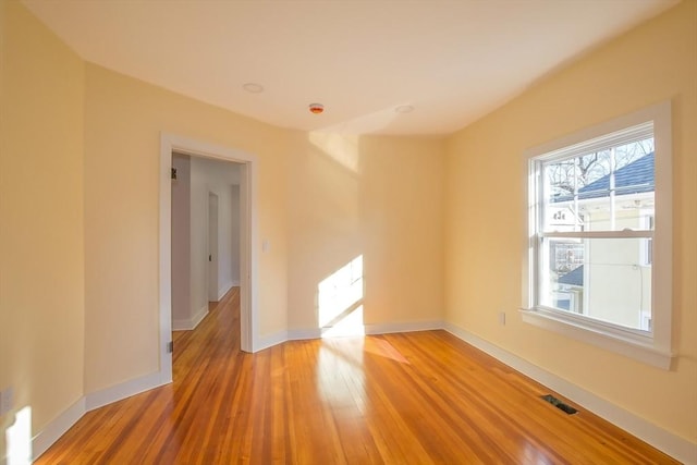 spare room with hardwood / wood-style flooring