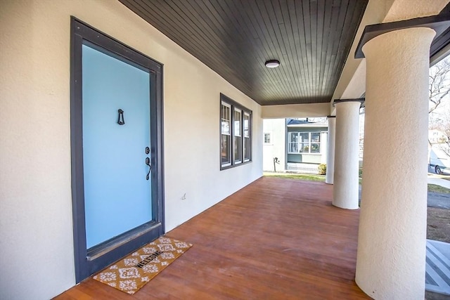 view of exterior entry featuring covered porch