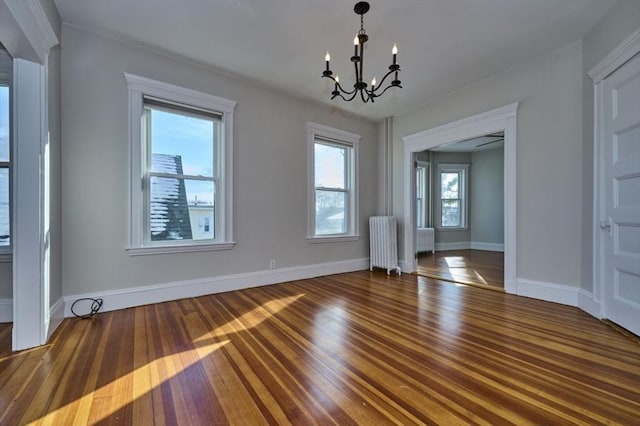 unfurnished dining area featuring radiator, a notable chandelier, and dark hardwood / wood-style floors