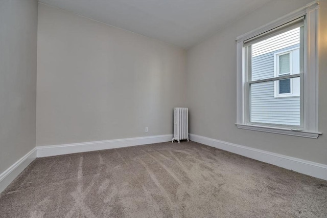 spare room with carpet flooring and radiator