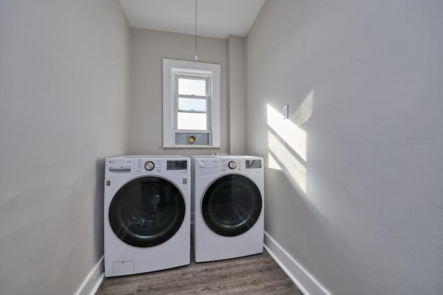 clothes washing area with wood-type flooring and washing machine and dryer