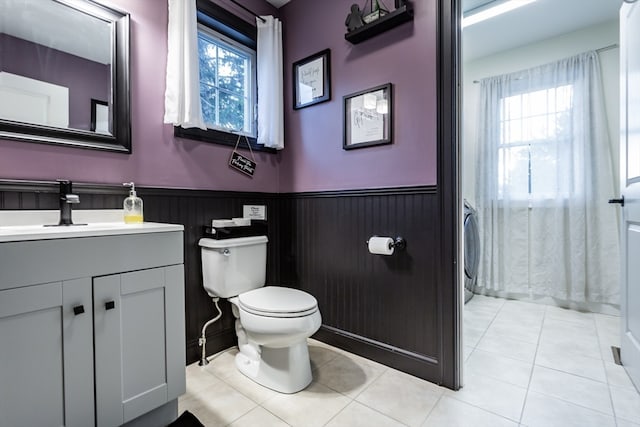 bathroom featuring tile patterned flooring, vanity, and toilet