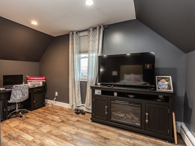 office with baseboard heating, light hardwood / wood-style flooring, and lofted ceiling