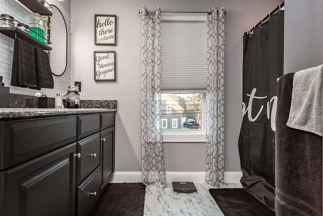 bathroom featuring vanity and tasteful backsplash