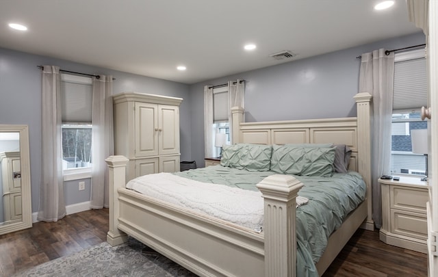 bedroom featuring dark hardwood / wood-style floors and multiple windows