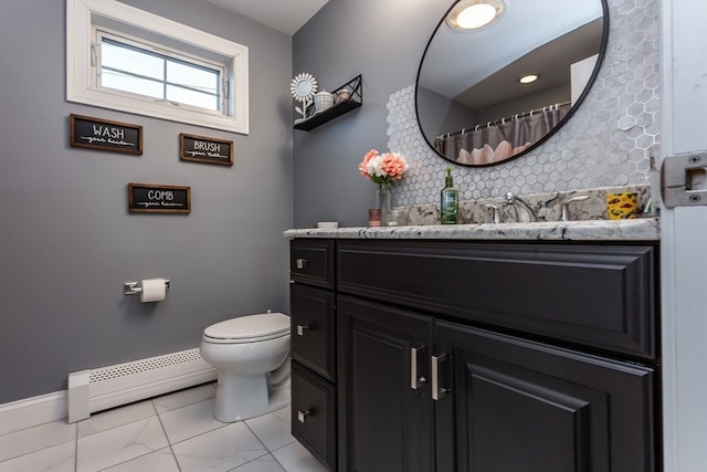 bathroom with baseboard heating, backsplash, vanity, and toilet