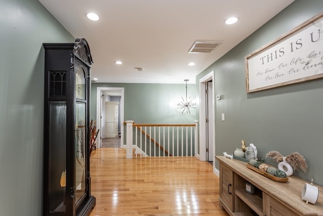 hallway with light hardwood / wood-style floors