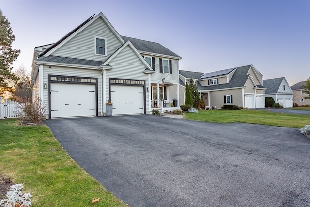 view of front facade featuring a front lawn and a garage