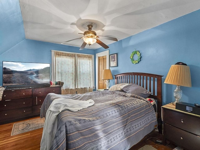 bedroom featuring ceiling fan, hardwood / wood-style floors, and vaulted ceiling