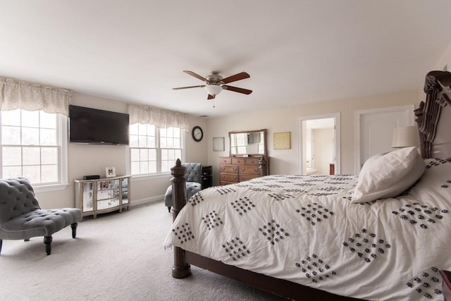 bedroom with carpet floors, ceiling fan, and ensuite bath