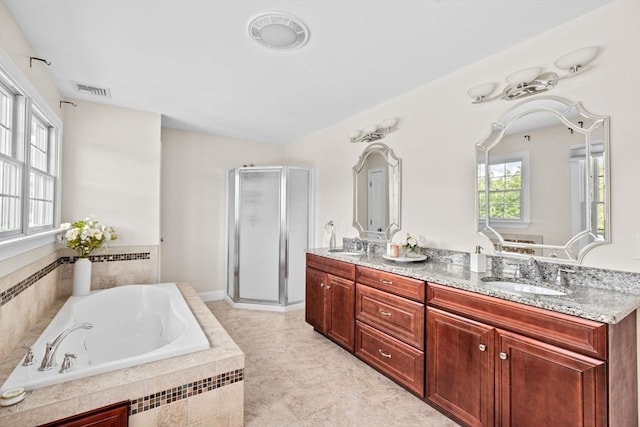 bathroom featuring vanity and independent shower and bath