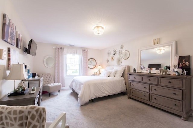 bedroom featuring light carpet