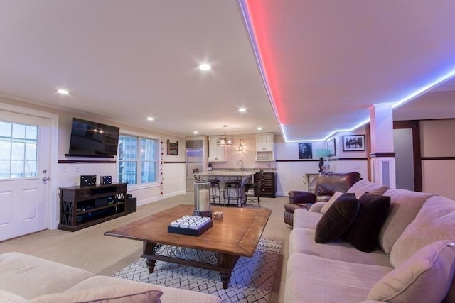 carpeted living room with crown molding and plenty of natural light