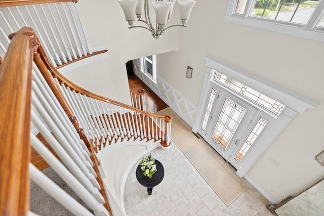 foyer with a high ceiling and a chandelier