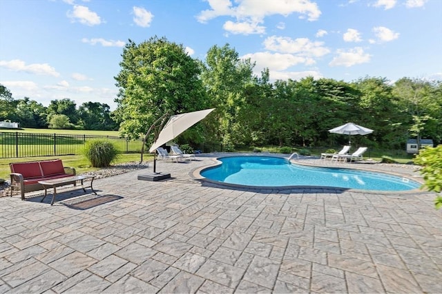 view of pool featuring an outdoor living space and a patio area