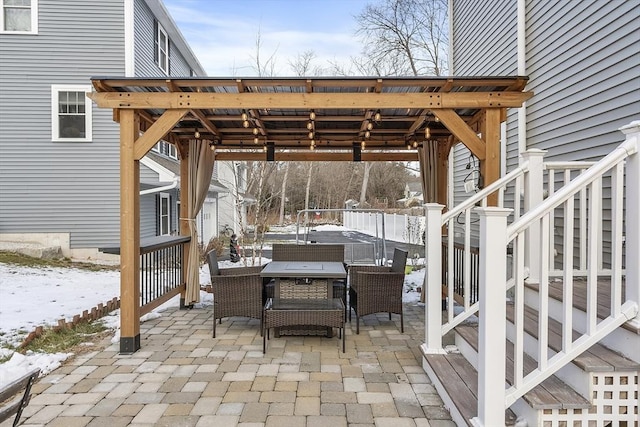 snow covered patio with a hot tub