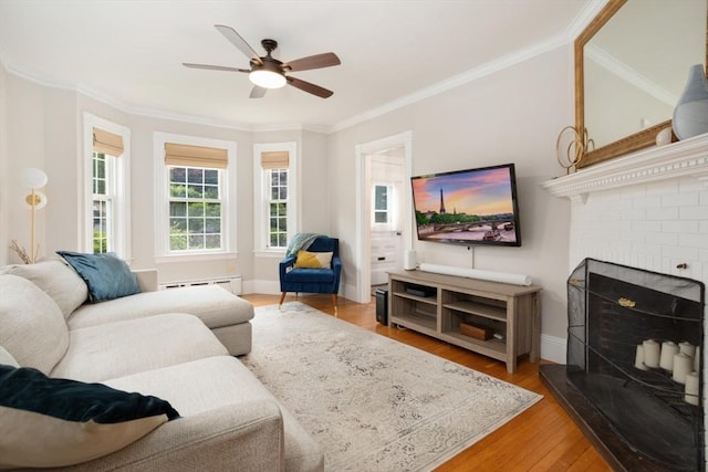 518 Washington St, Winchester, MA 01890 - living area with a ceiling fan, light wood finished floors, baseboard heating, crown molding, and baseboards