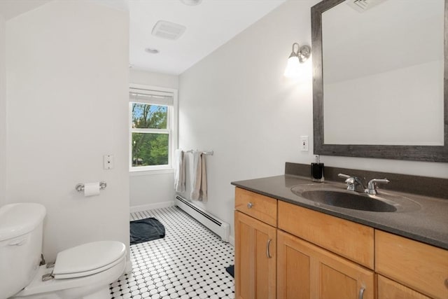 518 Washington St, Winchester, MA 01890 - bathroom featuring baseboard heating, toilet, vanity, and baseboards
