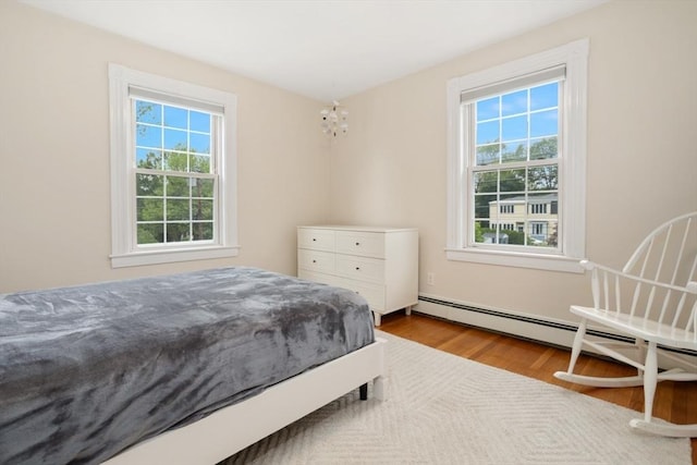 518 Washington St, Winchester, MA 01890 - bedroom featuring multiple windows, wood finished floors, and a chandelier