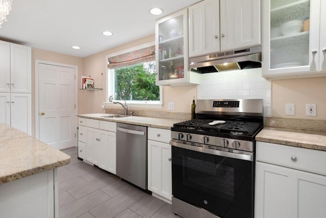 518 Washington St, Winchester, MA 01890 - kitchen featuring appliances with stainless steel finishes, under cabinet range hood, a sink, white cabinetry, and recessed lighting