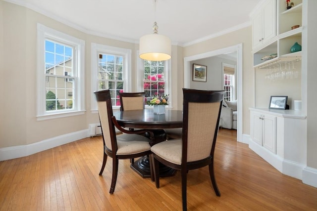518 Washington St, Winchester, MA 01890 - dining space with light wood-style flooring, baseboards, and crown molding