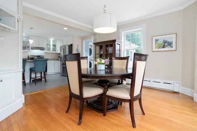 518 Washington St, Winchester, MA 01890 - dining room with a baseboard heating unit, light wood-type flooring, ornamental molding, recessed lighting, and stacked washer and clothes dryer