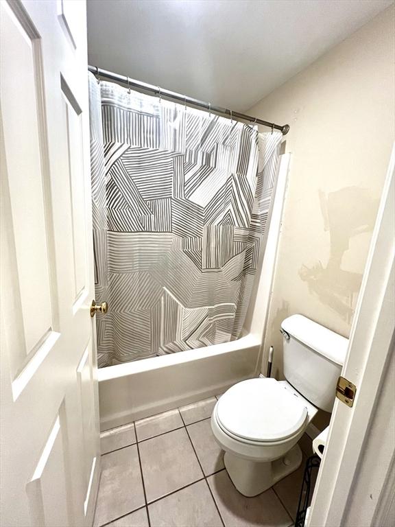 59 Sophia, Worcester, MA 01607 - bathroom featuring tile patterned floors, toilet, and shower / tub combo