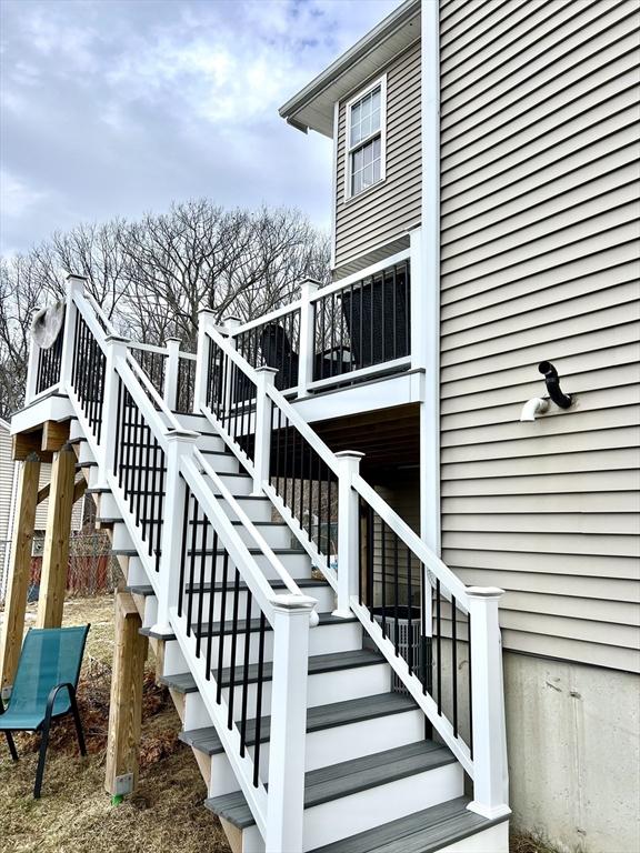 exterior space featuring stairs and a wooden deck