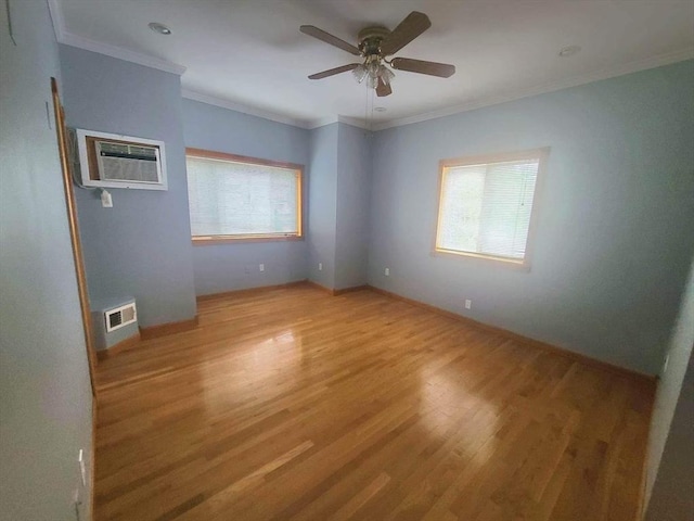 unfurnished room with crown molding, light wood finished floors, visible vents, a wall mounted AC, and a ceiling fan