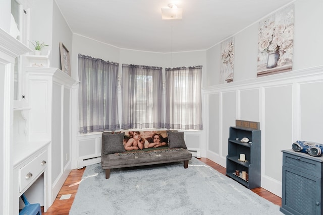 living area featuring a baseboard radiator and light hardwood / wood-style floors