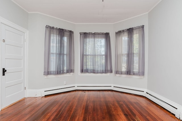 empty room featuring dark wood-type flooring and ornamental molding