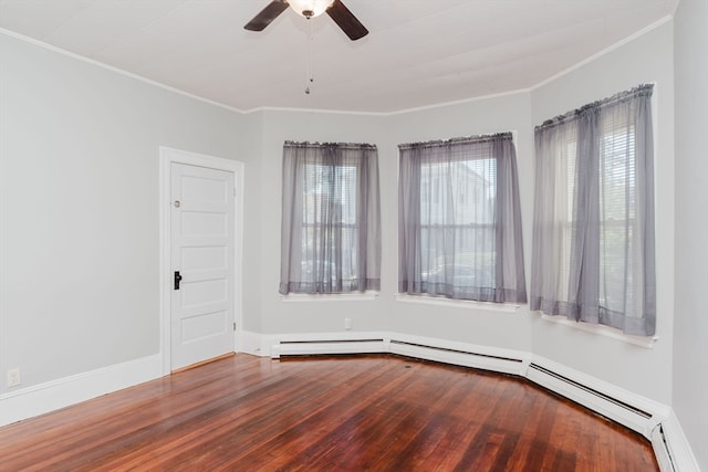 spare room featuring ornamental molding, ceiling fan, hardwood / wood-style floors, and a baseboard heating unit