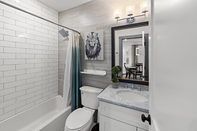 full bathroom featuring toilet, shower / bath combo with shower curtain, tile walls, and vanity