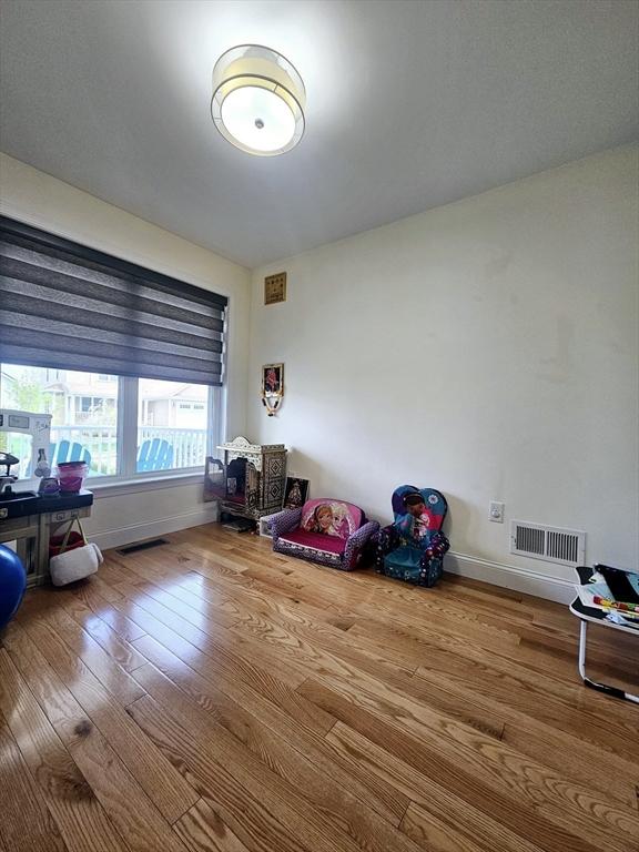 2 Carousel Ter, Dartmouth, MA 02747 - recreation room with hardwood / wood-style flooring, baseboards, and a wood stove