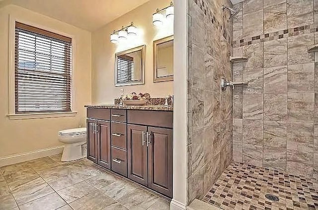 2 Carousel Ter, Dartmouth, MA 02747 - bathroom featuring baseboards, toilet, tiled shower, and vanity