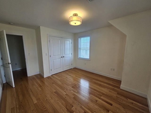 2 Carousel Ter, Dartmouth, MA 02747 - unfurnished bedroom with wood finished floors, baseboards, and a closet