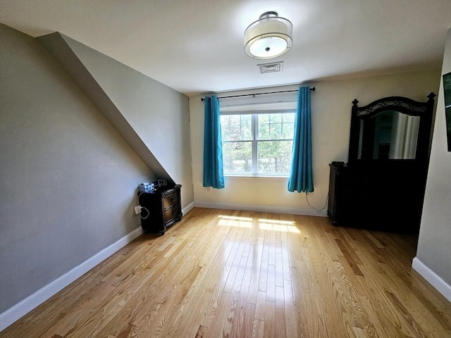 2 Carousel Ter, Dartmouth, MA 02747 - unfurnished living room featuring light wood-style floors, baseboards, and a wood stove