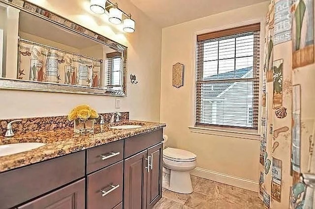 2 Carousel Ter, Dartmouth, MA 02747 - bathroom featuring baseboards, toilet, and double vanity