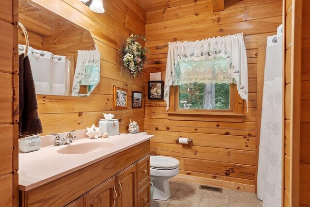 8 Turk Hollow Rd, Oxford, MA 01540 - bathroom with tile patterned flooring, visible vents, wooden walls, toilet, and vanity