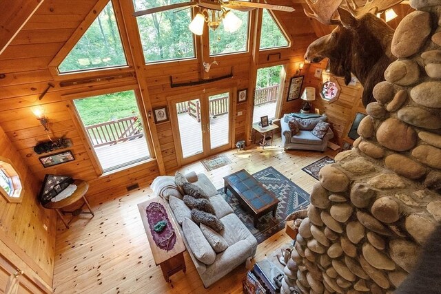 8 Turk Hollow Rd, Oxford, MA 01540 - living area with wooden walls, a high ceiling, hardwood / wood-style floors, and a ceiling fan